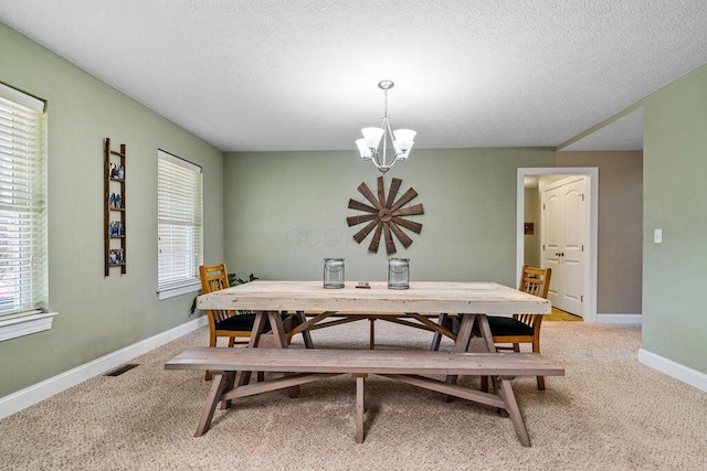 dining area with visible vents, light carpet, baseboards, and a chandelier