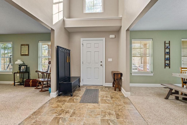 foyer entrance with a wealth of natural light and baseboards