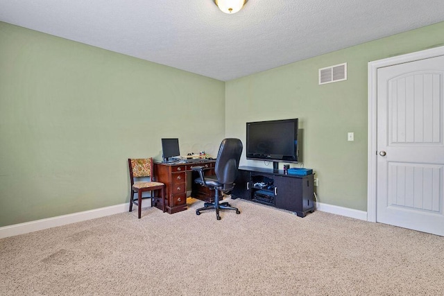 office with carpet flooring, baseboards, visible vents, and a textured ceiling