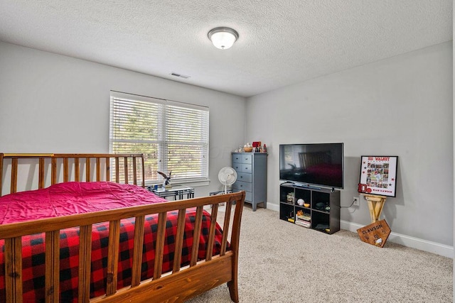 carpeted bedroom featuring visible vents, baseboards, and a textured ceiling