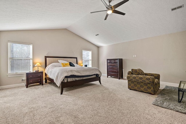 carpeted bedroom with lofted ceiling, multiple windows, visible vents, and ceiling fan