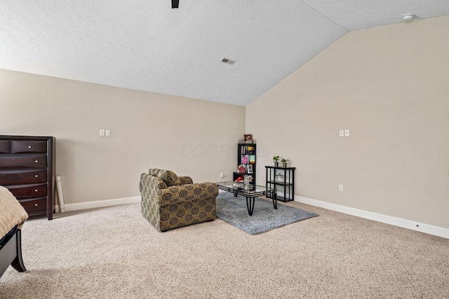 sitting room featuring visible vents, baseboards, carpet flooring, and vaulted ceiling