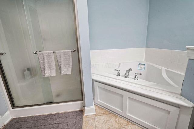 full bathroom featuring a garden tub, a shower stall, and tile patterned flooring