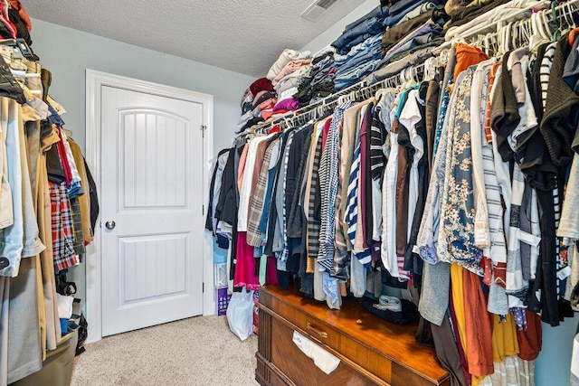 spacious closet with visible vents and carpet flooring