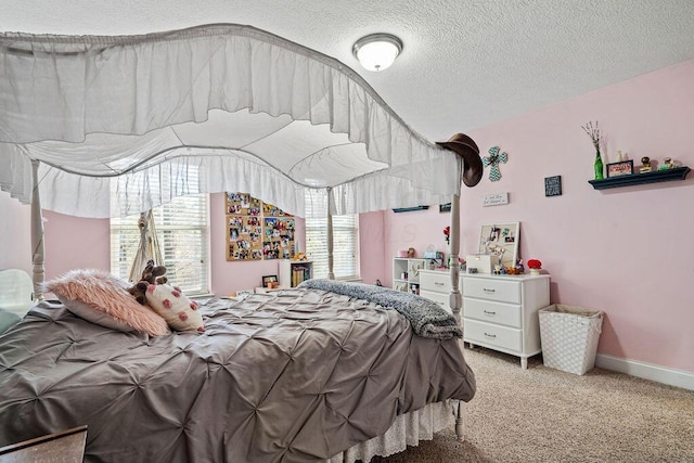 bedroom with light colored carpet, a textured ceiling, and baseboards