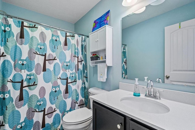 bathroom with vanity, curtained shower, toilet, and a textured ceiling