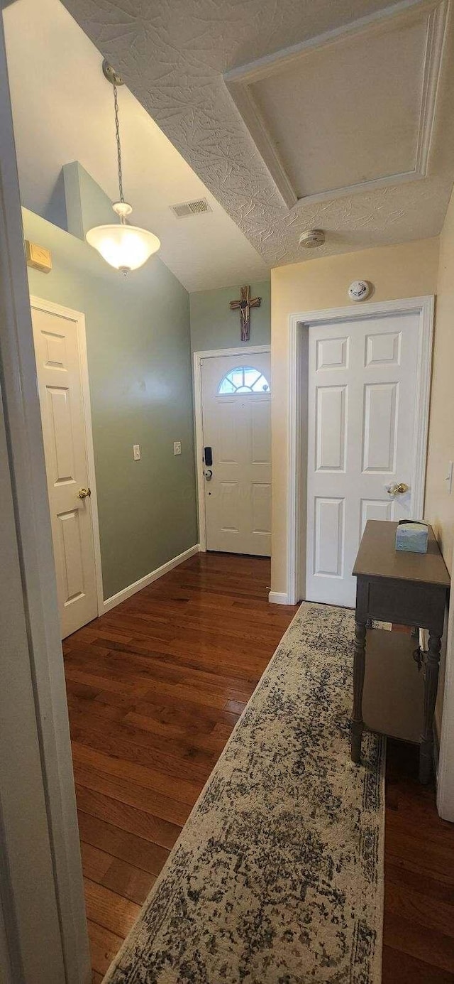 entrance foyer with a textured ceiling and dark wood-type flooring