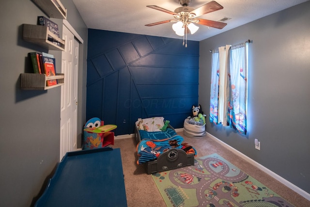 bedroom with a closet, ceiling fan, and carpet flooring