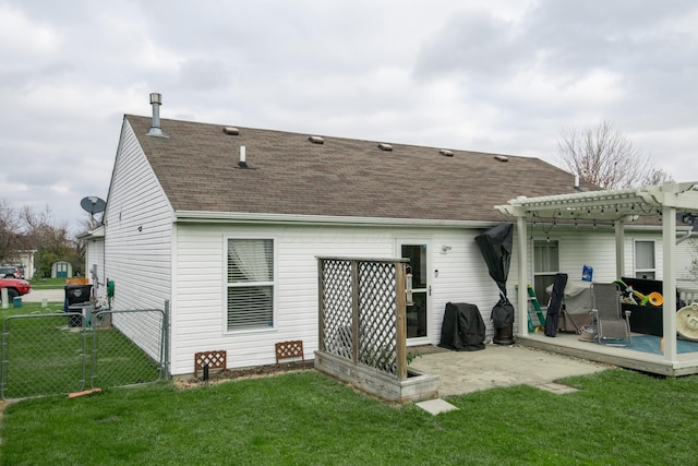 rear view of house with a yard, a pergola, and a patio