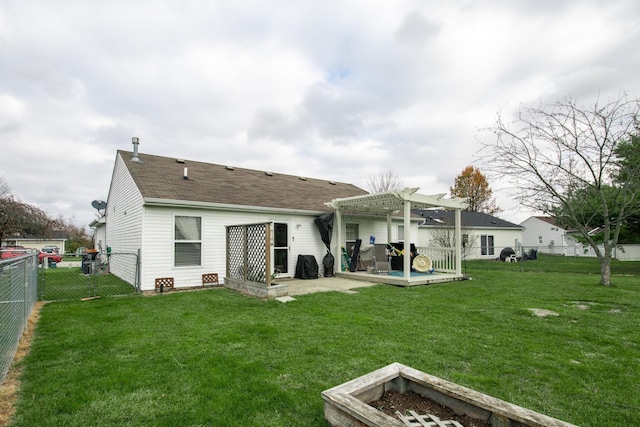 back of property with a pergola, a lawn, and a patio