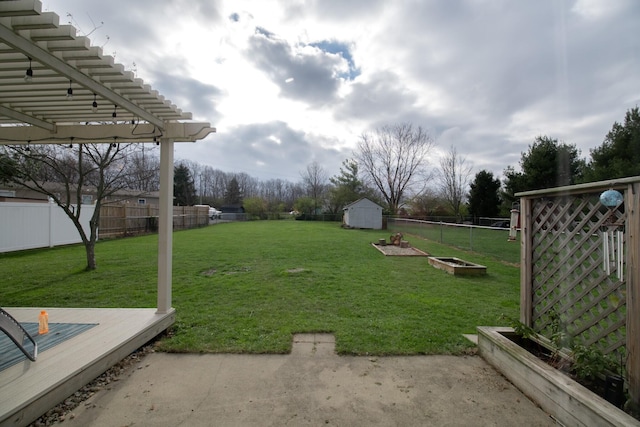 view of yard with a storage unit, a pergola, and a deck