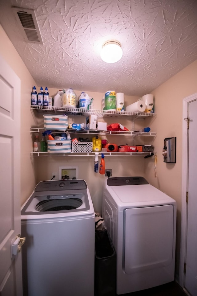 washroom with washing machine and clothes dryer