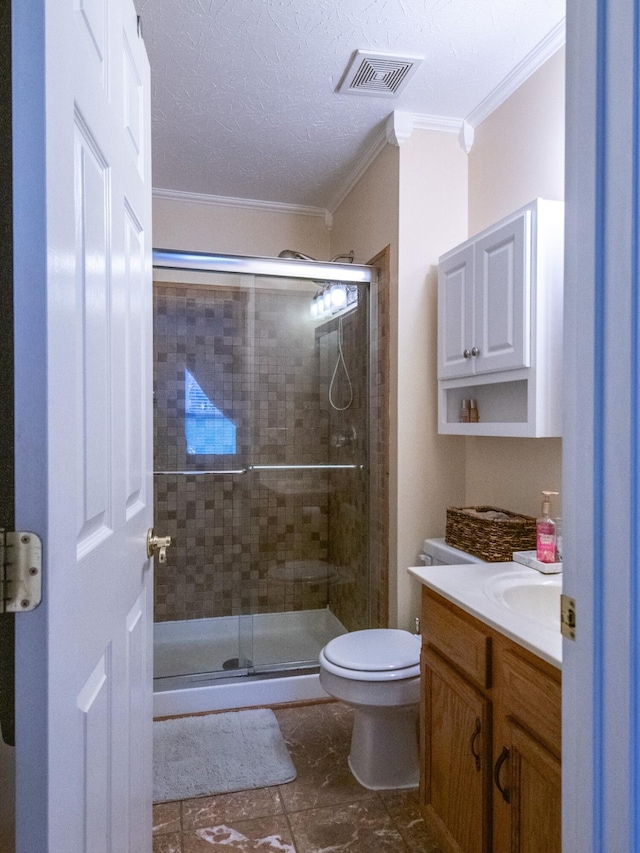 bathroom featuring vanity, a shower with shower door, ornamental molding, and toilet