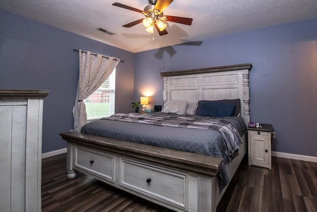 bedroom with dark hardwood / wood-style flooring, a textured ceiling, and ceiling fan