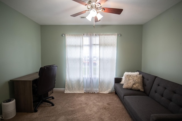 carpeted home office featuring ceiling fan