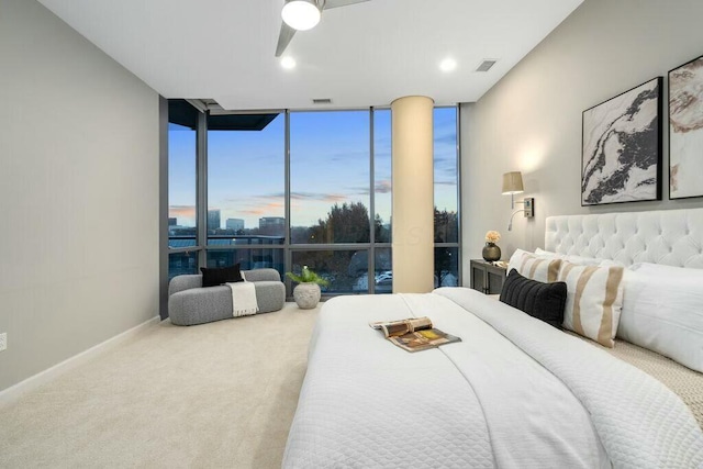 carpeted bedroom with ceiling fan and expansive windows