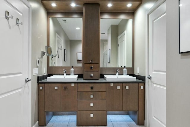 bathroom with tile patterned flooring and vanity