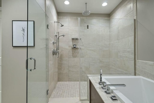 bathroom featuring separate shower and tub