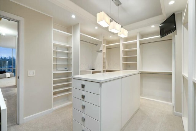 walk in closet featuring light carpet