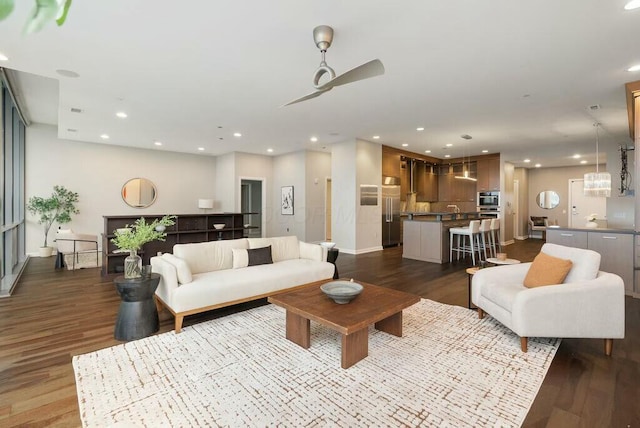 living room with ceiling fan and dark wood-type flooring