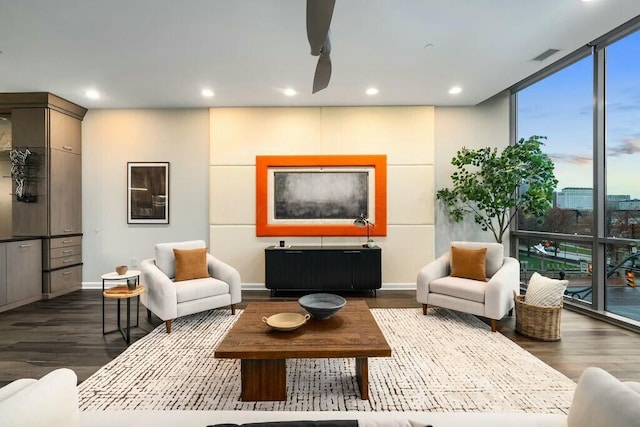 living room featuring ceiling fan and dark hardwood / wood-style flooring