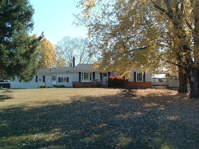 back of property featuring a lawn