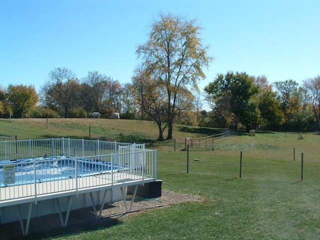 view of yard featuring a rural view and a covered pool