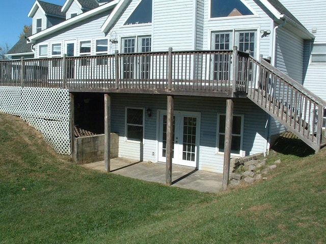 rear view of house with a yard, a deck, and a patio area