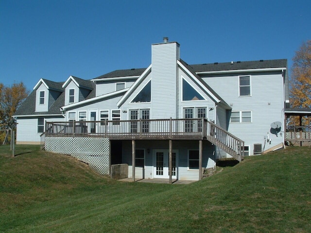 back of house with a lawn, a wooden deck, and central AC unit