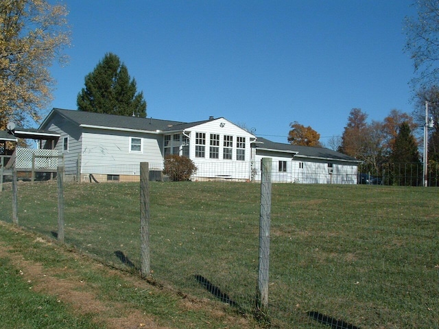 rear view of property with a yard