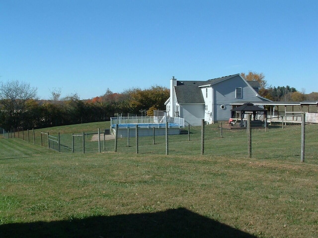 view of yard featuring a gazebo, a trampoline, and a rural view