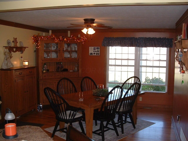 dining area with dark hardwood / wood-style floors, ceiling fan, and ornamental molding