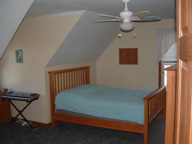 bedroom featuring ceiling fan, dark carpet, and lofted ceiling