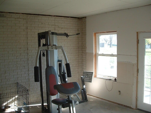 exercise area featuring brick wall