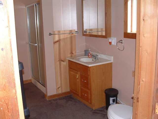 bathroom with vanity, toilet, and an enclosed shower