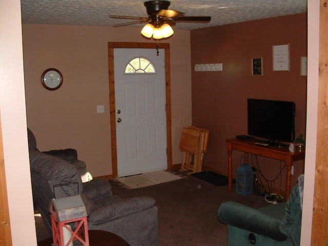 carpeted living room featuring ceiling fan and a textured ceiling