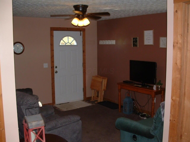 entrance foyer featuring ceiling fan and a textured ceiling