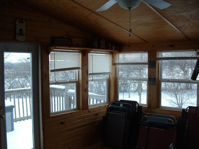 sunroom / solarium featuring vaulted ceiling, ceiling fan, and wooden ceiling