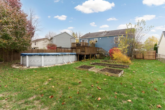 view of yard with a swimming pool side deck