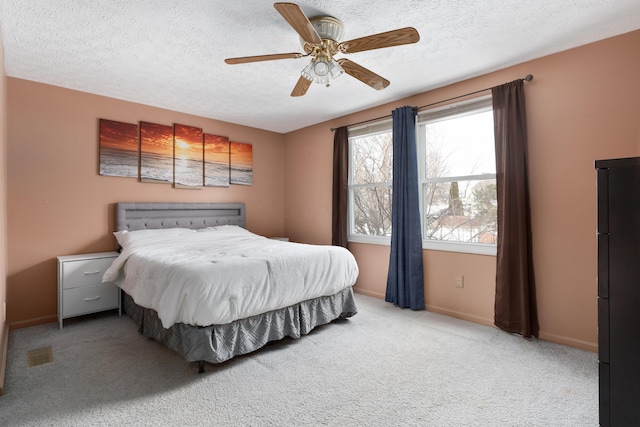 carpeted bedroom with ceiling fan, a textured ceiling, and refrigerator