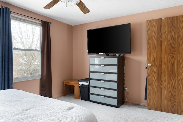 carpeted bedroom with ceiling fan