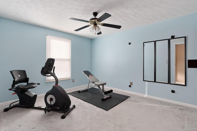 workout room with ceiling fan, carpet floors, and a textured ceiling