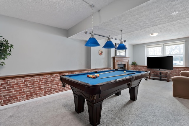 playroom with brick wall, light carpet, a textured ceiling, and billiards