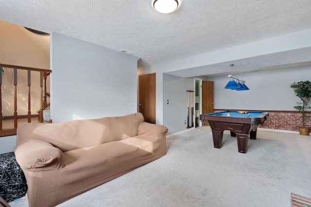 rec room with carpet floors, a textured ceiling, and billiards