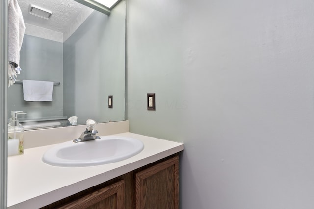 bathroom with vanity and a textured ceiling