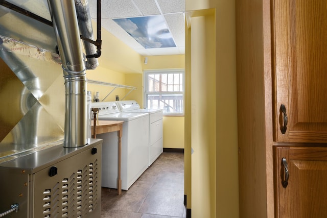 laundry room featuring washing machine and clothes dryer and tile patterned floors