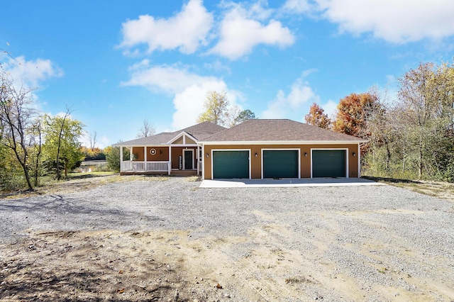 view of front of house featuring a porch and a garage