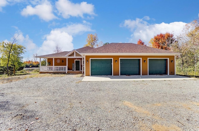 view of front of property featuring a porch and a garage