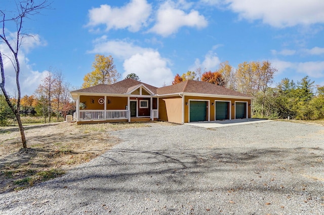 view of front of property featuring covered porch and a garage