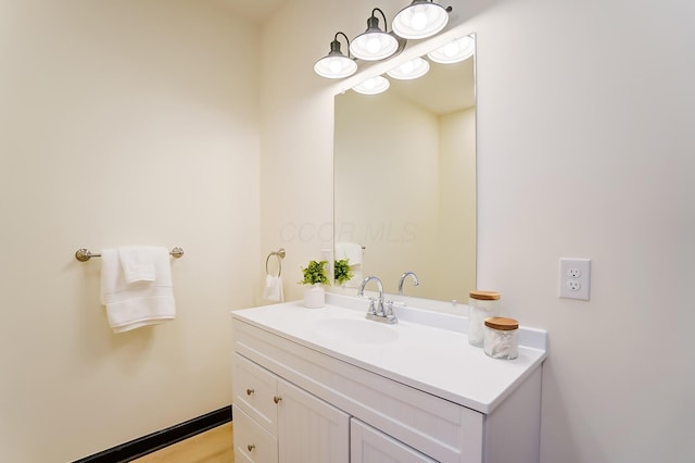 bathroom with hardwood / wood-style floors and vanity